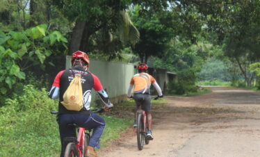 Two cycle riders experiencing cycling adventure