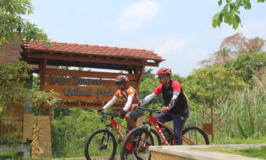 Two cycle riders at wetland park in Sri Lanka