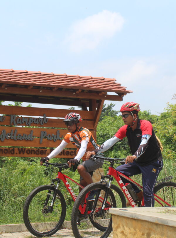Two cycle riders at wetland park in Sri Lanka